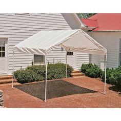 a white tent sitting on top of a brick patio