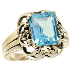 At its heart of this vintage-inspired ring lies a magnificent octagonal-cut natural blue topaz, exuding a captivating azure hue that evokes visions of clear skies on a sunny day. This stunning gemstone is a true marvel of nature, its brilliance further accentuated by the intricate floral yellow gold setting that envelops it with warmth and charm. Whether worn as a symbol of love and commitment or as a treasured heirloom, this ring is sure to make a statement wherever it goes. CHARACTERISTICS Sta Luxury Victorian Yellow Gold Topaz Ring, Luxury Vintage Topaz Ring Collectible, Luxury Heirloom Topaz Ring With Intricate Design, Luxury Heirloom Yellow Gold Topaz Ring, Luxury Yellow Gold Blue Topaz Rings, Luxury Antique Topaz Ring, Luxury Heirloom Topaz Collectible Ring, Topaz Yellow, Vintage Style Rings