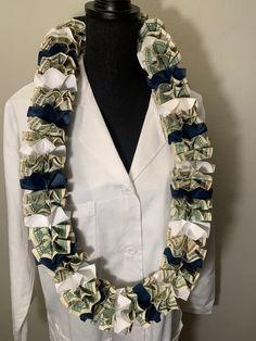 a woman wearing a white shirt and blue ribbon around her neck with money on it