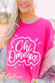 Looking for a trendy sorority tee that'll last? 🫶🏻 This Chi Omega Airbrush Hot Pink Tee is the answer! Whether you're giving this tee as a gift or treating yourself with something new, you'll be obsessed with this sorority t-shirt! 🌊 YOU'LL LOVE THIS STYLE 🌊 Meet the Chi Omega Airbrush Hot Pink Tee - a dreamy sorority t-shirt! This basic tee is a classic style that's everyone's go-to. The soft, breathable fabric makes it comfortable to wear all day long, and the hot pink color makes styling Pink Sorority T-shirt With Crew Neck, Relaxed Fit Pink Top With Lettering, Pink Sorority T-shirt For Spring, Pre-shrunk Crew Neck Sorority T-shirt, Pre-shrunk Sorority T-shirt With Crew Neck, Pink School Spirit Top With Screen Print, Sorority Crew Neck T-shirt, Sorority T-shirt With Graphic Print And Crew Neck, Pink Short Sleeve Sorority Tops