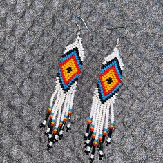 Tradicional Colors Native American Jewelry Beaded Earrings New. Native American Style Earrings American Indian Beaded Earrings American Pattern This Is A Lovely Pair Of Traditional Colors (White,Blue, Red, Yellow, And ,Black ) In Geometric Designs In Czech Beads. All Hand Made By Embera Indians. They Are Duster Earrings And Would Make A Great Gift Or To Treat Yourself They Measure 3.5 Inches In Length And 0.75 Inches Wide, Not Including The Ear Wires. Bohemian Style White Single Earring, Traditional White Earrings With Ear Wire, White Festival Earrings For Pierced Ears, Traditional White Beaded Earrings For Gift, White Beaded Dangle Earrings For Festival, White Dangle Beaded Earrings For Festival, Adjustable White Beaded Earrings, White Teardrop Dangling Beads Jewelry, White Teardrop Jewelry With Dangling Beads