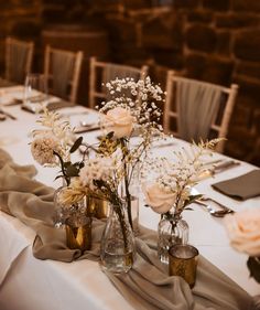 the table is set with flowers and place settings