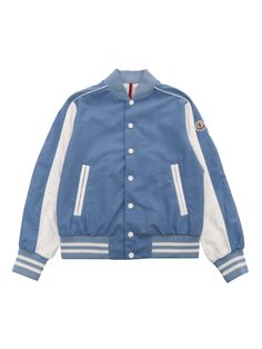 Moncler light blue Kobby bomber jacket for children with contrasting front buttoning, slanted pockets, elastic hem with web stripes, contrasting under sleeve, logo plate on the sleeve.Composition: 100% COTTON SLEEVES 100% POLYAMIDE 1 MATERIAL 100% POLYAMIDE INTERIOR LINING 100% POLYESTER Blue Varsity Jacket With Baseball Collar, Blue Outerwear With Baseball Collar For Spring, Blue Varsity Jacket With Ribbed Cuffs And Baseball Collar, Casual Cotton Outerwear With Contrast Stripes, Casual Varsity Jacket With Contrast Stripes, Casual Blue Outerwear With Baseball Collar, Sporty Light Blue Cotton Outerwear, White Cotton Outerwear With Striped Cuffs, Blue Sporty Outerwear With Padded Collar