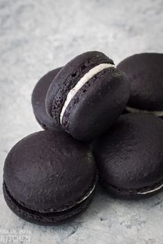 four chocolate macaroons stacked on top of each other