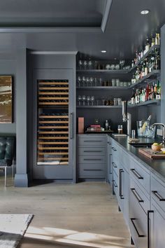 a kitchen with lots of bottles on the shelves