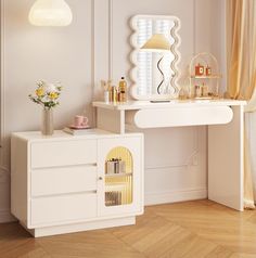 a white table with a mirror, vase and other items on it in a room