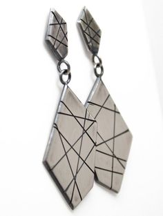 A modern play on sterling silver dangle earrings.  These earrings are hand made from recycled sterling silver sheet.  The design is sawed by hand and polished to a matte finish.  The silver has been oxidized to add depth and beauty.  Solid 925 Sterling SilverAbout 2" L x .75" WPost style with deluxe Luxlock Backs-Safe, Secure, ComfortableArtisan made in TexasThe earrings will arrive thoughtfully packaged in a signature jewelry box. Click here to see all of my earrings:  https://www.etsy.com/shop Modern Geometric Sterling Silver Earrings, Modern Handmade Long Drop Linear Earrings, Silver Geometric Pierced Earrings, Sterling Silver Geometric Earrings, Modern Soldered Sterling Silver Earrings, Modern Silver Linear Earrings As Gift, Handmade Silver Geometric Earrings, Handmade Sterling Silver Geometric Jewelry, Handmade Geometric Sterling Silver Jewelry