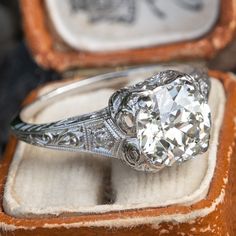 an old - fashioned diamond ring sits in its box