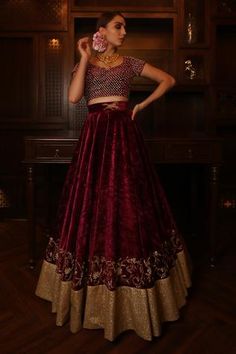 Maroon lehenga with embroidered hem and placement embroidered waistband. Comes with studded blouse and sheer dupatta.
Component: 3
Pattern: Embroidered
Type Of Work: Cutdana, Zardozi, Pearl
Neckline: Leaf Shaped
Sleeve Type: Cap
Fabric: Velvet, Net
Color: Maroon
Other Details: 
Back tassel tie-up blouse
Placement embroidered waistband
Occasion: Bride - Aza Fashions Maroon Lehenga, Sheer Dupatta, Embroidered Hem, Types Of Work, Luxury Sale, Bridal Lehenga, Leaf Shapes, Sheer Blouse, Set For Women