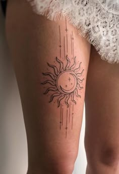 a woman's thigh with a sun and stars tattoo on it