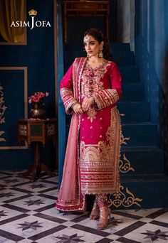 Shirt: Lawn By Pcs: 3 Pcs Trouser: Cambric Dupatta: Chiffon Color: Red Product Details Bask in the beauty of a ruby rose with this earth red ensemble paired with a petal pink dupatta. Like petals unfolding, intricate aari stitching and gold lurex adorn the shirt with 9mm and 3mm sequins scattered delicately while gracing the borders. The embroidered neckline for front blooms with elegance while the embroidered sleeves with borders exude grace. With embroidered border for chaak and daman as well Pakistani Suit Salwar, Pakistani Boutique, 8th March, Wedding Dresses Indian, Pakistani Designer Clothes, Asim Jofa, Pakistani Lawn Suits, Festive Collection, Chiffon Collection