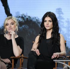 two women sitting next to each other in chairs