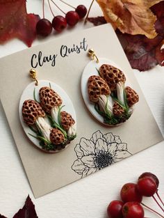 the earrings are made from clay and decorated with flowers, leaves, and other things