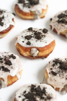 several donuts with white frosting and chocolate chips