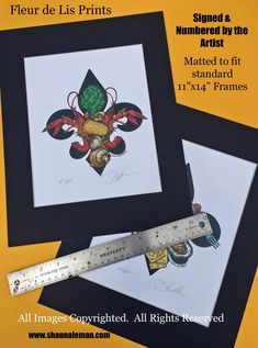 three framed pictures are on display with a ruler in the foreground and an image of a fleur de lis prints