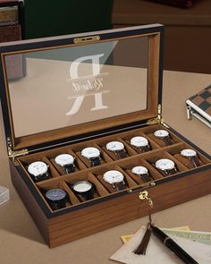 an open wooden watch box sitting on top of a table