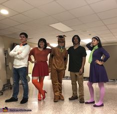 four people dressed up in costumes posing for a photo