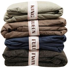 five folded shirts stacked on top of each other with the words king and queen printed on them