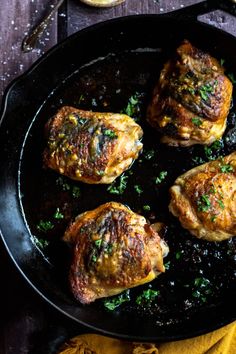 four cooked meats in a skillet with parsley on the side, ready to be eaten