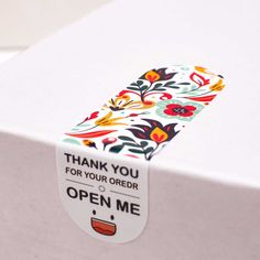 an open box with a floral design on the lid and thank you for your order