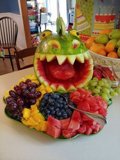 a plate with fruits and vegetables in the shape of a dragon's mouth on it