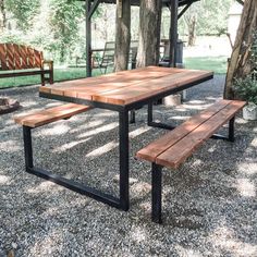 a picnic table with benches in the background