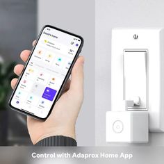 someone is holding their cell phone in front of an appliance with the text control with adaptox home app