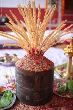 there is a wooden barrel with some flowers in it on the table and another plate next to it