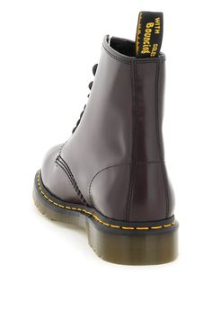 Elevate your style with these iconic combat boots from Dr. Martens. Crafted in smooth original leather, these boots feature a classic lace-up closure with eight eyelets in lacquered metal, a rounded toe, and the brand's iconic contrasting stitching on the base. The rear loop tab in branded ribbon adds a touch of luxury to this timeless silhouette. With a leather and fabric lining, and a durable rubber sole, these boots are as comfortable as they are stylish. Whether you're dressing up a casual l Branded Ribbon, Winter Heels, Lace Up Combat Boots, Latest Fashion Design, Boots Uk, Balenciaga Designer, Favorite Dress, Burgundy Red, Dr. Martens