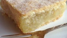 a piece of cake sitting on top of a white plate next to a fork and knife