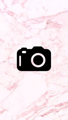 an image of a camera that is on the wall with pink and white marble behind it