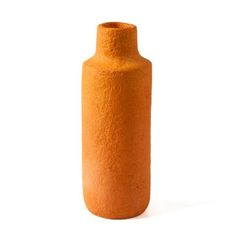 an orange vase sitting on top of a white surface