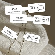 four price tags attached to a chain on a white fabric background with the words add $ 4 00 and $ 5 00