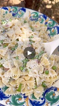 a bowl filled with pasta and peas on top of a table