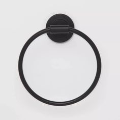 a black towel ring on a white wall