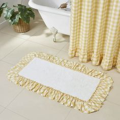 a white rug sitting on top of a bathroom floor next to a bath tub