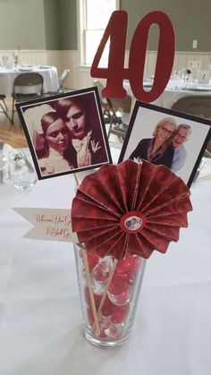 the table is set up with pictures and candles for an anniversary party or special occasion