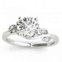 a white gold engagement ring set with a round diamond center stone and two diamonds on the band