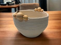 a white bowl sitting on top of a wooden table