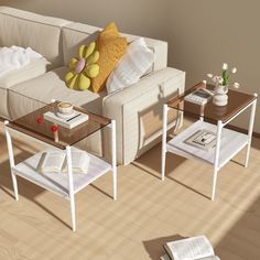 a white couch sitting next to a wooden table on top of a hard wood floor