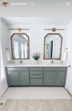 a bathroom with two sinks and large mirrors on the wall above them is decorated in white and gray