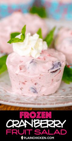 frozen cranberry fruit salad on a plate with mint garnish and whipped cream