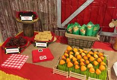 a table topped with lots of food next to a red barn door covered in wood planks