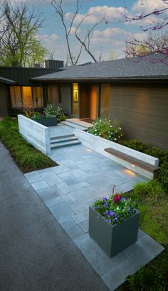 a modern house with landscaping in the front yard