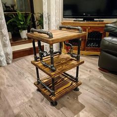 a wooden table with pipes on it in front of a tv