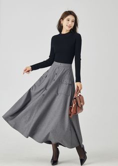 "Introducing our gray wool maxi skirt with two front pockets, a versatile addition to your winter wardrobe. The neutral gray color exudes sophistication, while the premium wool fabric guarantees warmth and comfort. The thoughtful addition of front pockets combines style with functionality. This maxi skirt is perfect for everyday wear or special occasions, ensuring you stay both chic and cozy throughout the season. DETAILS * 30% wool blend, 40% fiber and polyester, 40% nylon * Full polyester lini Gray Workwear Skirt With Pockets, Elegant Gray Skirt With Pockets, Winter Full Maxi Skirt With Pockets, Fall Gray Skirt With Pockets, Long Wool Skirt, Winter Skirt, Wool Clothing, Wool Skirts, Gray Skirt