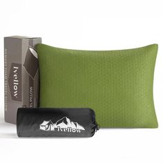 a green pillow next to a black bag