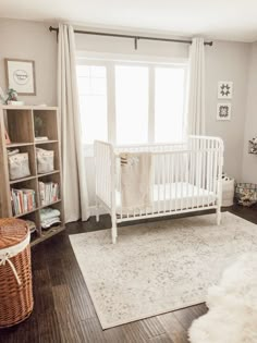 a baby's room with a crib, bookshelf and rugs