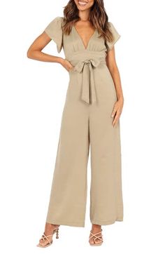 Fluttery short sleeves frame this open-back jumpsuit designed with a dipped neckline, wide legs and a matching tie cinching the waist. Hidden back-zip closure; ties at neck Deep V-neck Short sleeves Removable sash Partially lined 100% polyester Hand wash, dry flat Imported Spring Solid Color Jumpsuits And Rompers With Tie Back, Spring Jumpsuits And Rompers With Tie Back, Spring Tie Back Jumpsuits And Rompers, Elegant Short Sleeve Romper With Ruffles, Casual Summer Jumpsuit With Flutter Sleeves, Chic Short Sleeve Jumpsuits And Rompers For Summer, Chic Summer Jumpsuits And Rompers With Short Sleeves, Chic Belted Short Sleeve Jumpsuit, Chic Belted Jumpsuit With Short Sleeves