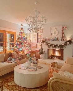 a living room filled with furniture and a christmas tree